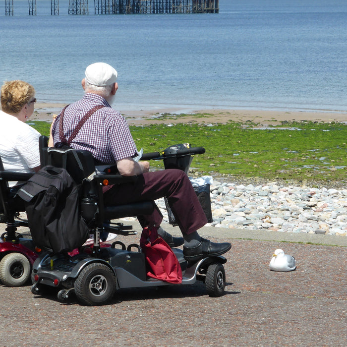 A traveller outdoors with a mobility scooter